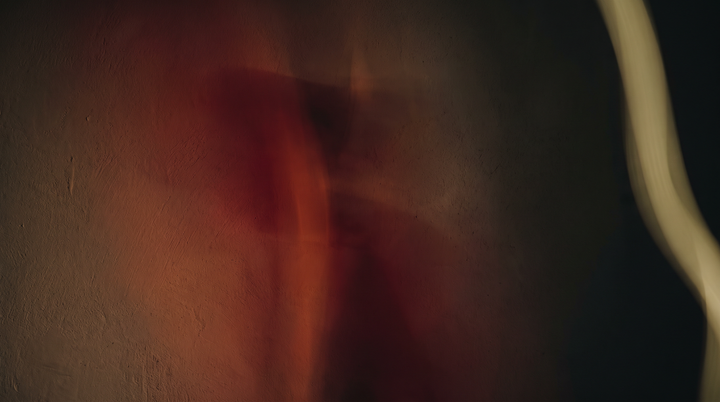 Gradient of deep red light fading into darkness