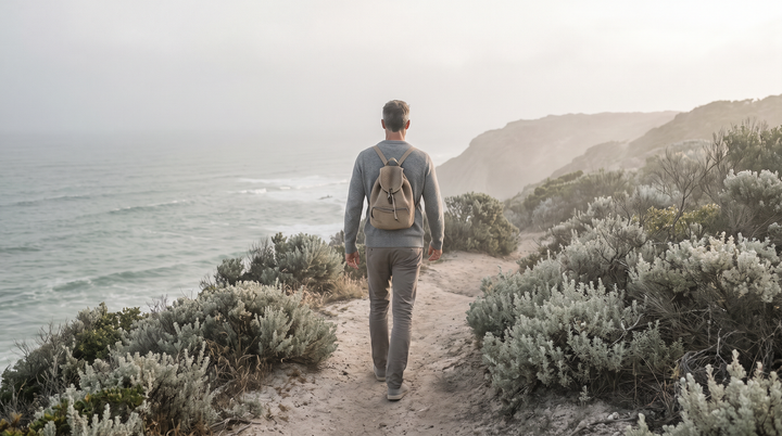 Man in his late fifties walking a coastal path at dawn