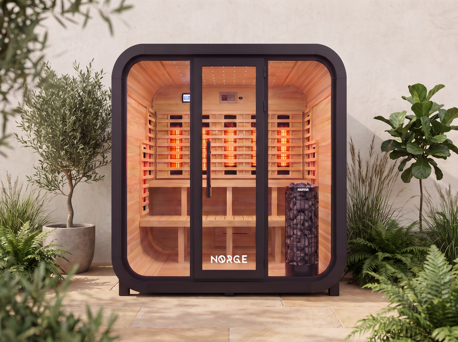 NØRGE Kube 4 person sauna in matte black, courtyard with plants