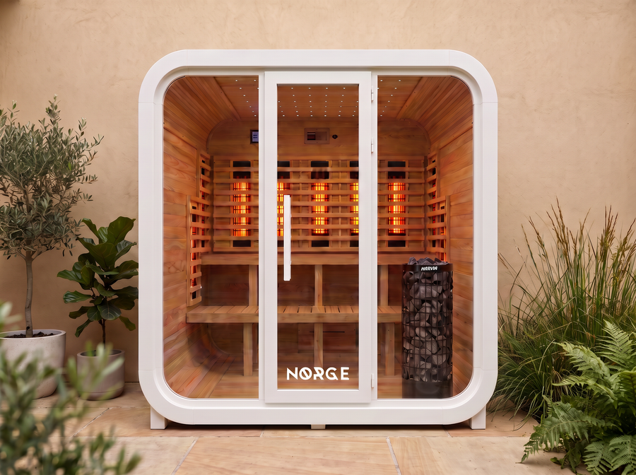 NØRGE Kube 4 person sauna in matte white, courtyard with plants