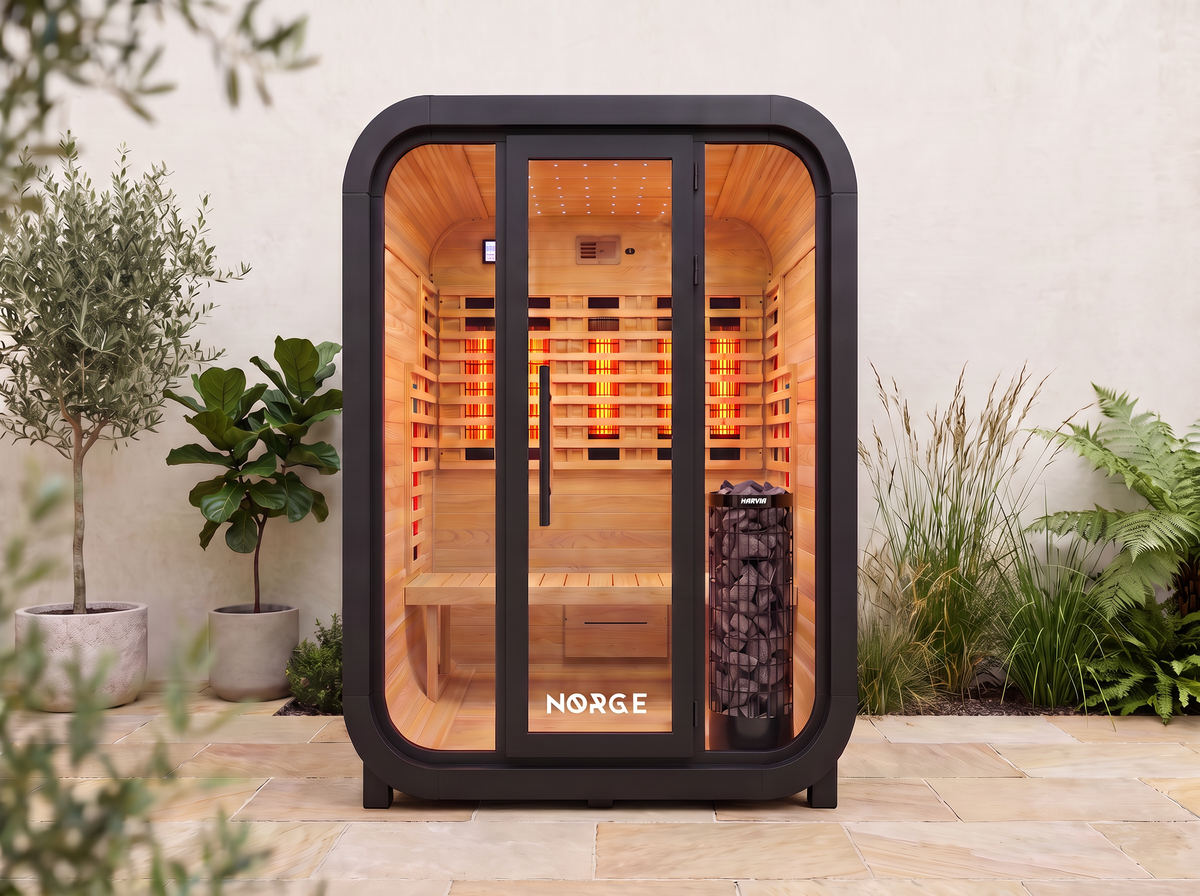 NØRGE Kube 2 person sauna in matte black, courtyard with plants
