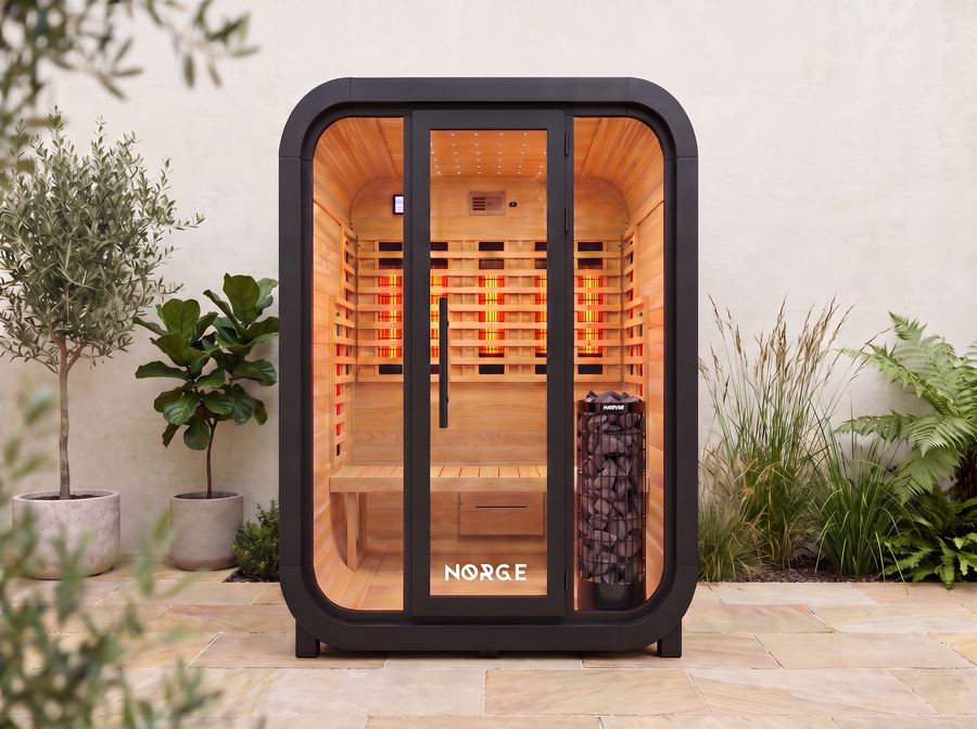 NØRGE Kube 2 person sauna in matte black, courtyard with plants