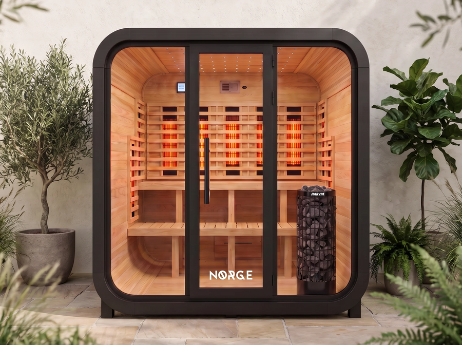 NØRGE Kube 6 person sauna in matte black, courtyard with plants